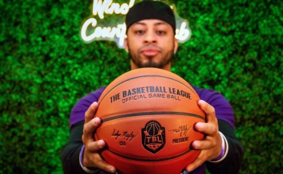 Photo of team owner Rze Culbreath holding a official TBL basketball in his outstretched hands.